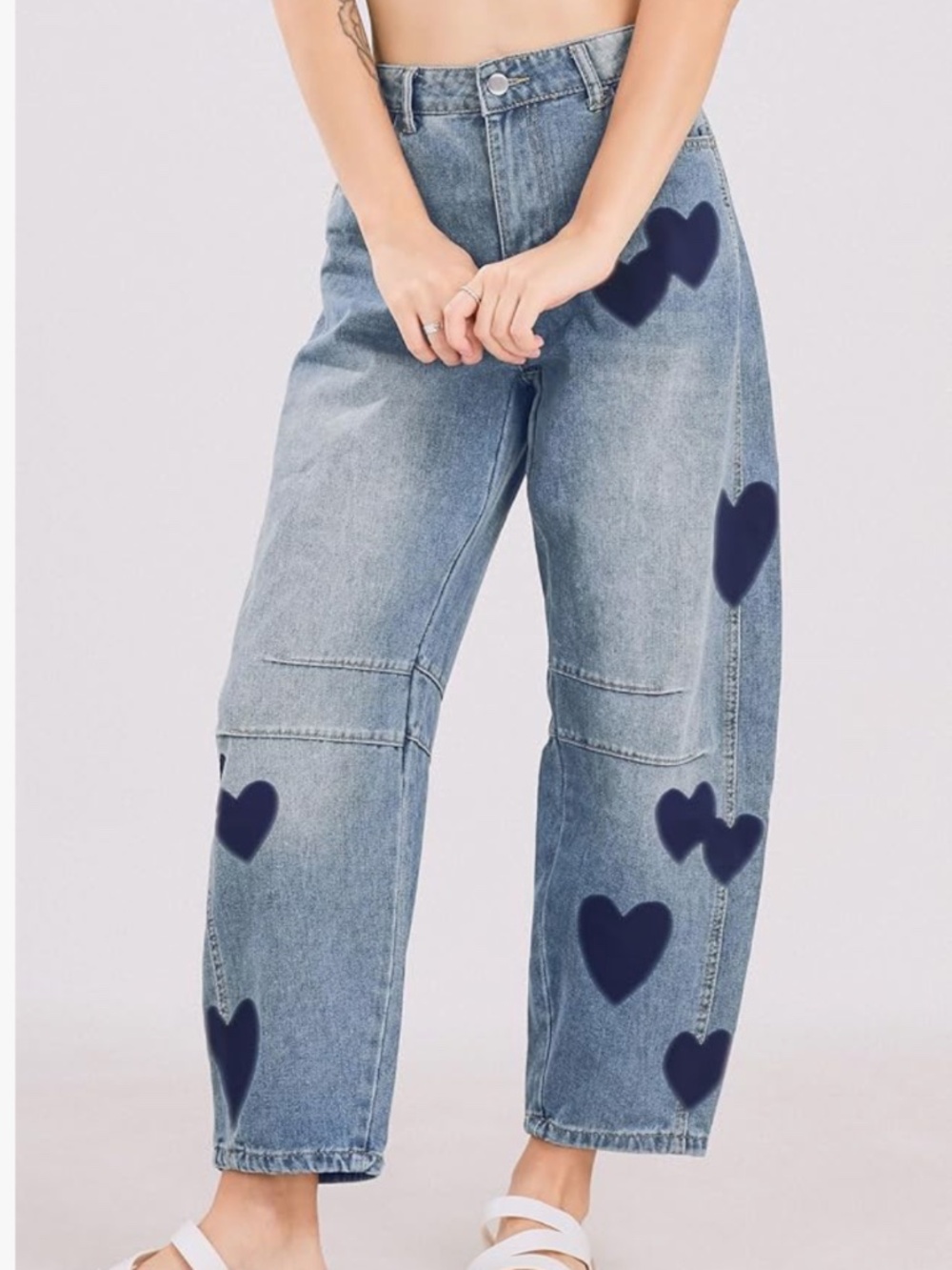 Relaxed-fit light blue jeans with playful navy heart prints. High-rise waist and
